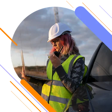 female worker in safety gear using walkie talkie